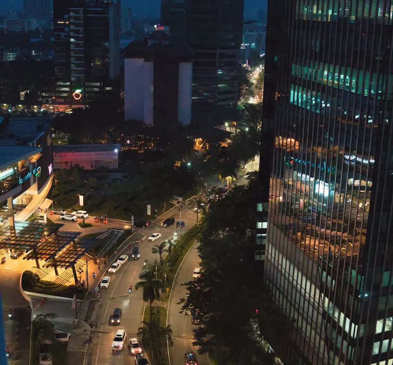 Cebu City at dusk with lit office towers and traffic below