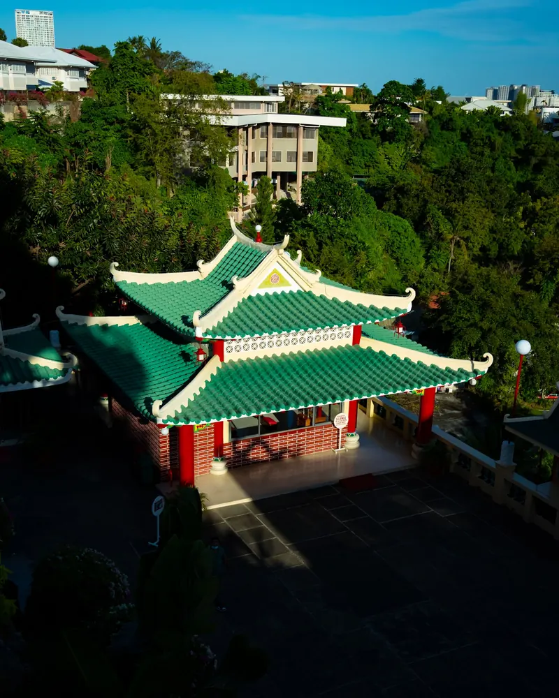 The Cebu Taoist Temple with green tiled roofs surrounded by trees